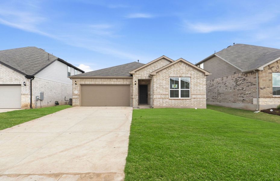 Front exterior of a new home in Lagos, Manor, TX, highlighting curb appeal (Image 21). Front exterior of a new home in Lagos, Manor, TX, highlighting curb appeal (Image 21).