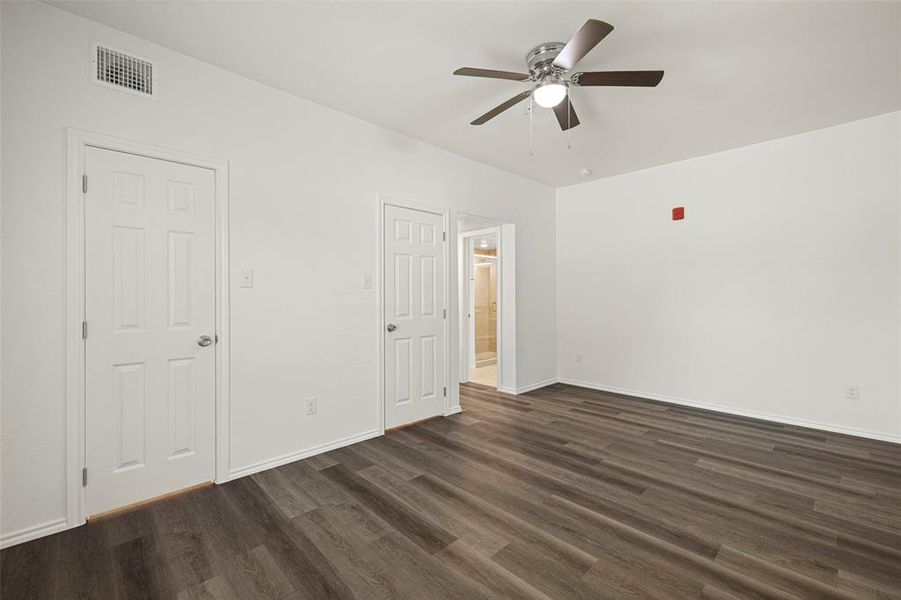 Featuring dark hardwood / wood-like flooring and ceiling fan