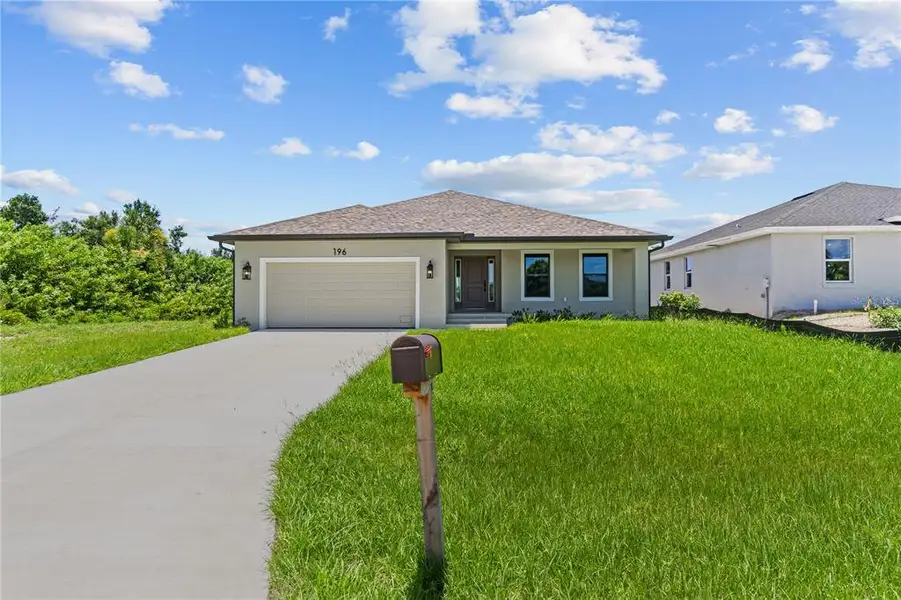Front exterior of a new home in , Rotonda West, FL, highlighting curb appeal (Image 1). Front exterior of a new home in , Rotonda West, FL, highlighting curb appeal (Image 1).