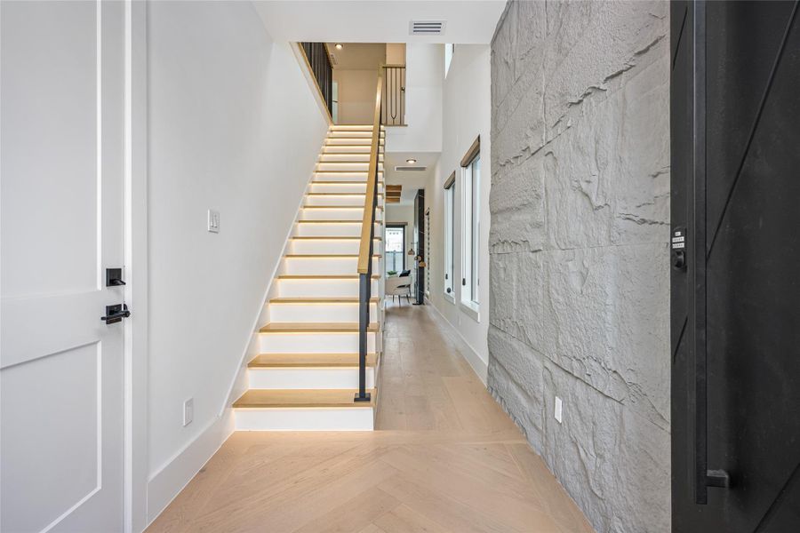 Optional stone fascia, a custom chandelier, and rich engineered wood floors create a dramatic, yet warm entry. Optional stone fascia, a custom chandelier, and rich engineered wood floors create a dramatic, yet warm entry.