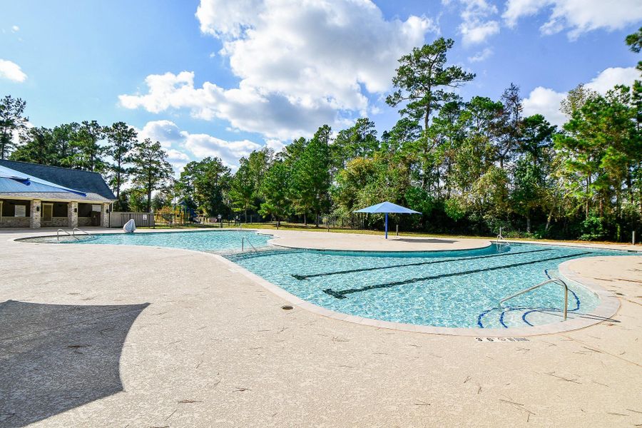 A spacious community pool area surrounded by lush trees, featuring a large swimming pool and lazy river, perfect for relaxation and social gatherings. An ideal spot for families and outdoor enthusiasts. A spacious community pool area surrounded by lush trees, featuring a large swimming pool and lazy river, perfect for relaxation and social gatherings. An ideal spot for families and outdoor enthusiasts.
