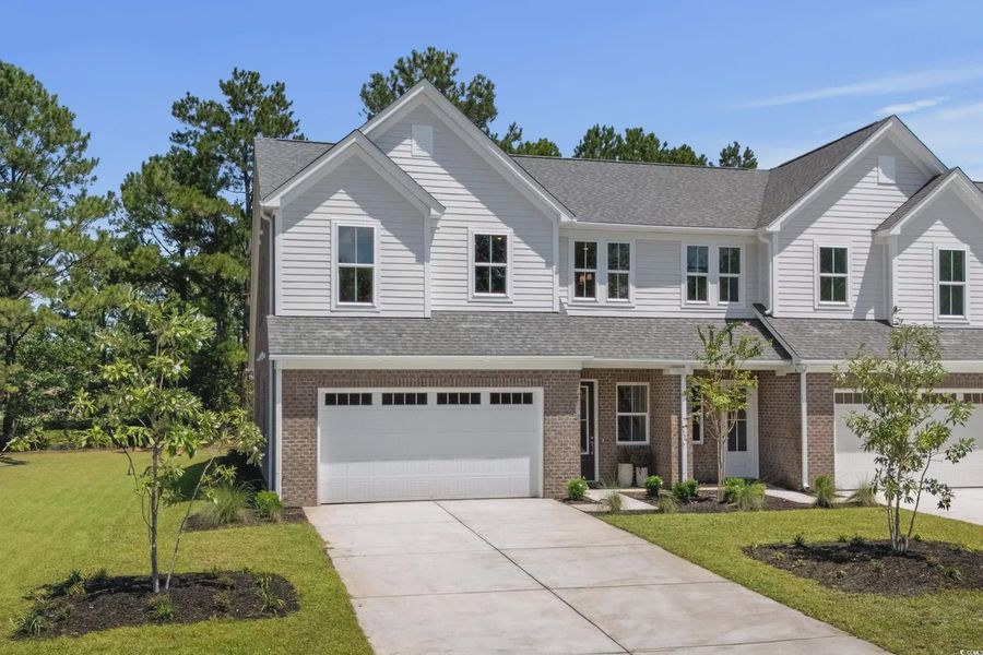 Front exterior of a new home in Long Bay Golf Club, Longs, SC, highlighting curb appeal (Image 2).