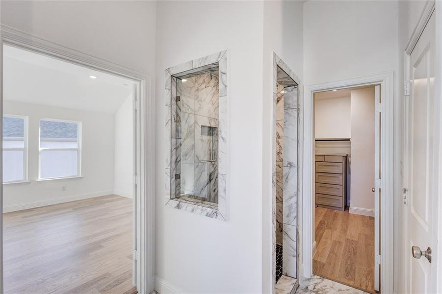 Hallway with light hardwood / wood-style flooring