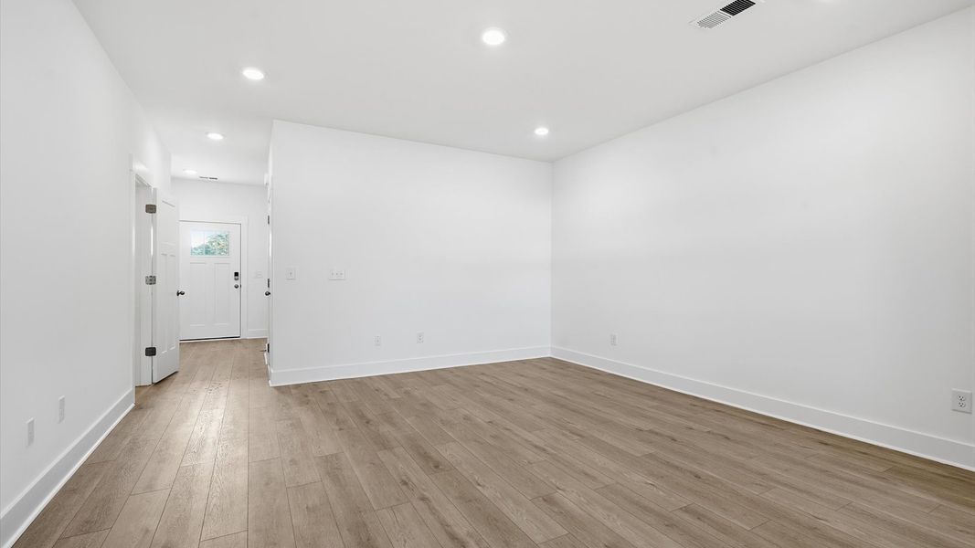 Elegant family room featuring hardwood flooring and thoughtful architectural detail at the Saluda Crossing community