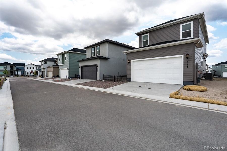 Front exterior of a new home in Revel Crossing at Wolf Ranch – The Ascent Collection, Colorado Springs, CO, highlighting curb appeal (Image 19).