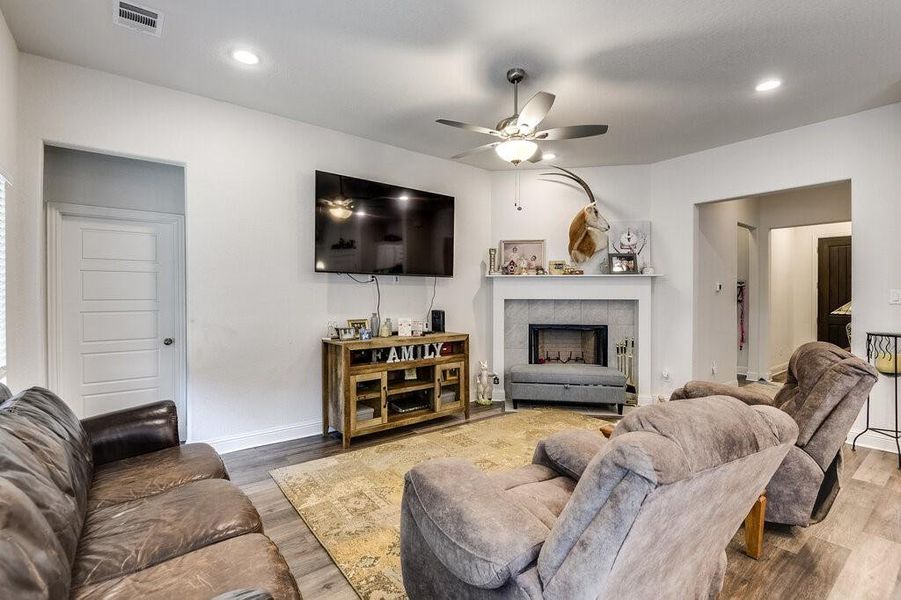 Experience a bright and airy living room, complete with a charming fireplace that adds warmth and character to your home.