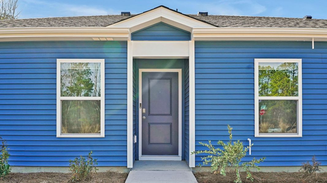 Front exterior of a new home in Indigo Preserve Townhomes, Leland, NC, highlighting curb appeal (Image 2).