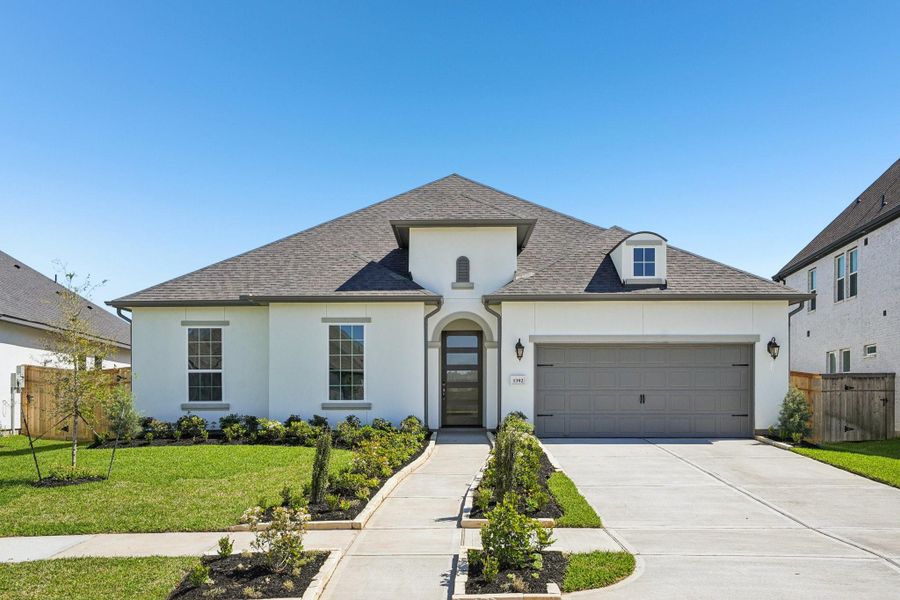 Front exterior of a new home in Sienna 65', Missouri City, TX, highlighting curb appeal (Image 18).