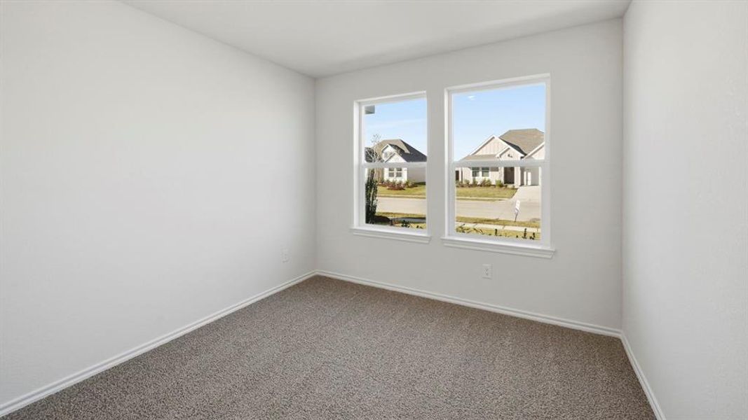 Carpeted spare room featuring baseboards Carpeted spare room featuring baseboards