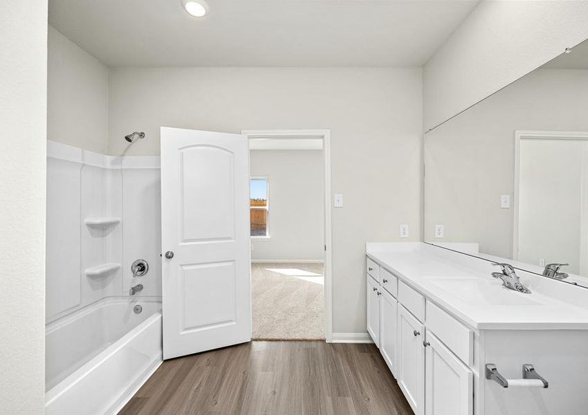 This bathroom has a combined bath and shower.