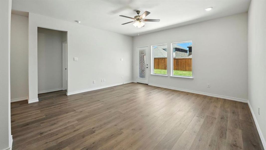 Spare room featuring wood finished floors and a ceiling fan