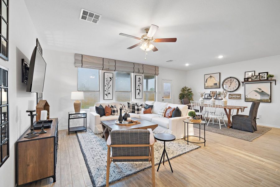 A living room with a large ceiling fan. A living room with a large ceiling fan.