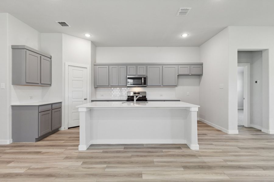 Kitchen in the Quartz home plan by Trophy Signature Homes – REPRESENTATIVE PHOTO