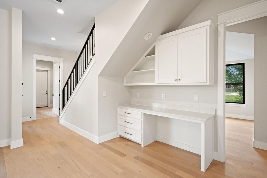 Integrated workspace beneath the staircase offers efficient design and functional elegance. Integrated workspace beneath the staircase offers efficient design and functional elegance.