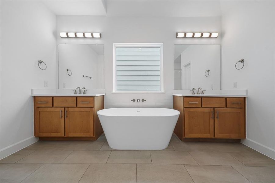 Step into the spa-like Primary Bath! The space features two vanities, custom cabinets, and stunning quartz countertops. (Sample photos of a completed Lisbon floor plan. The image may feature alternative selections and/or upgrades.)