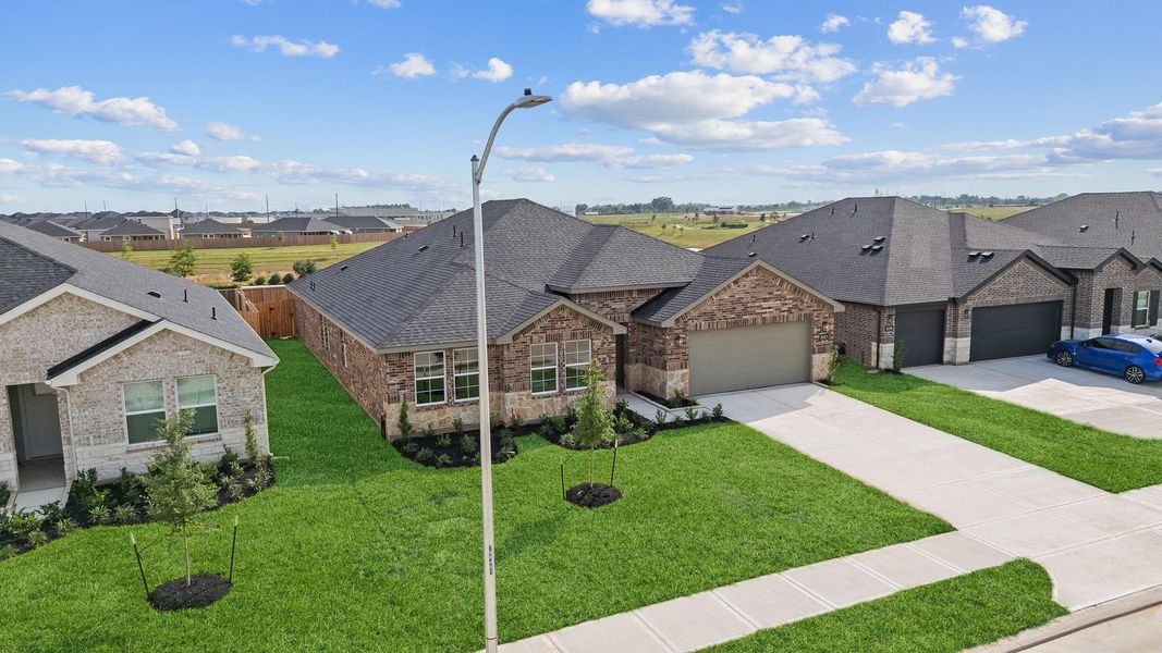 Front exterior of a new home in Tamarron, Fulshear, TX, highlighting curb appeal (Image 27).