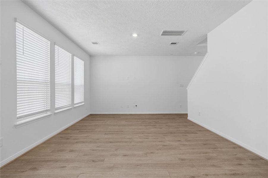 This bright and airy Great Room offers a spacious layout ideal for both relaxing evenings and lively gatherings. Designed for comfort and connection, it features Layton Lake vinyl plank flooring, large windows with blinds, high ceilings, recessed lighting, and seamless access to the stunning kitchen and dining—perfect for everyday living and entertaining alike. This bright and airy Great Room offers a spacious layout ideal for both relaxing evenings and lively gatherings. Designed for comfort and connection, it features Layton Lake vinyl plank flooring, large windows with blinds, high ceilings, recessed lighting, and seamless access to the stunning kitchen and dining—perfect for everyday living and entertaining alike.