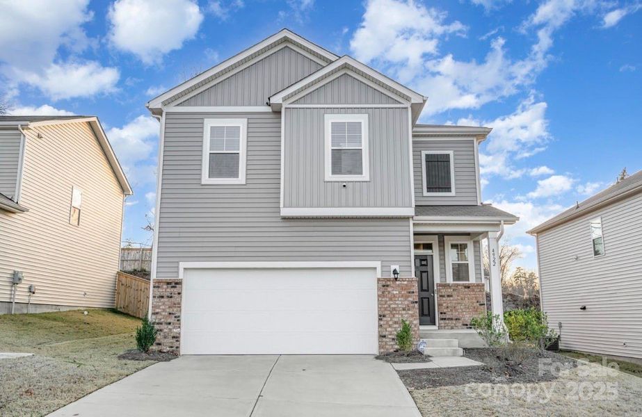 Front exterior of a new home in Freedom Greene, Charlotte, NC, highlighting curb appeal (Image 2). Front exterior of a new home in Freedom Greene, Charlotte, NC, highlighting curb appeal (Image 2).