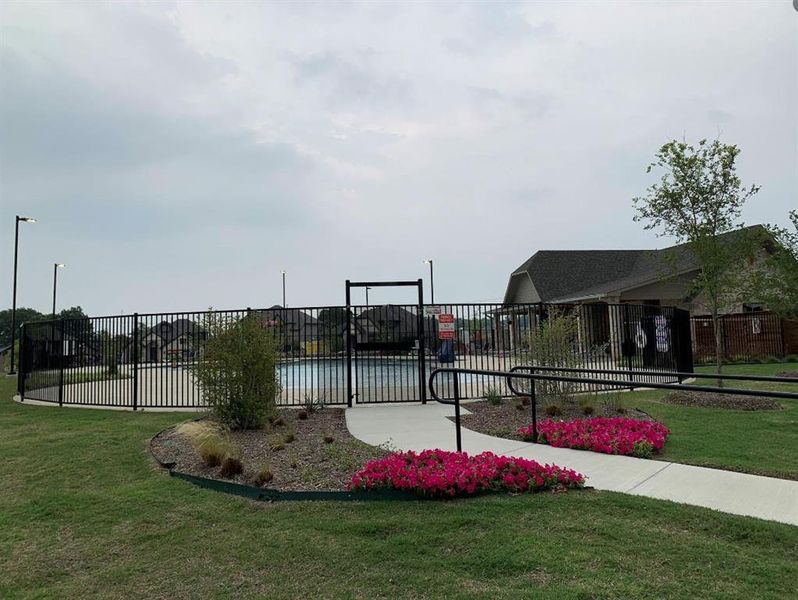 View of community with a pool and a yard