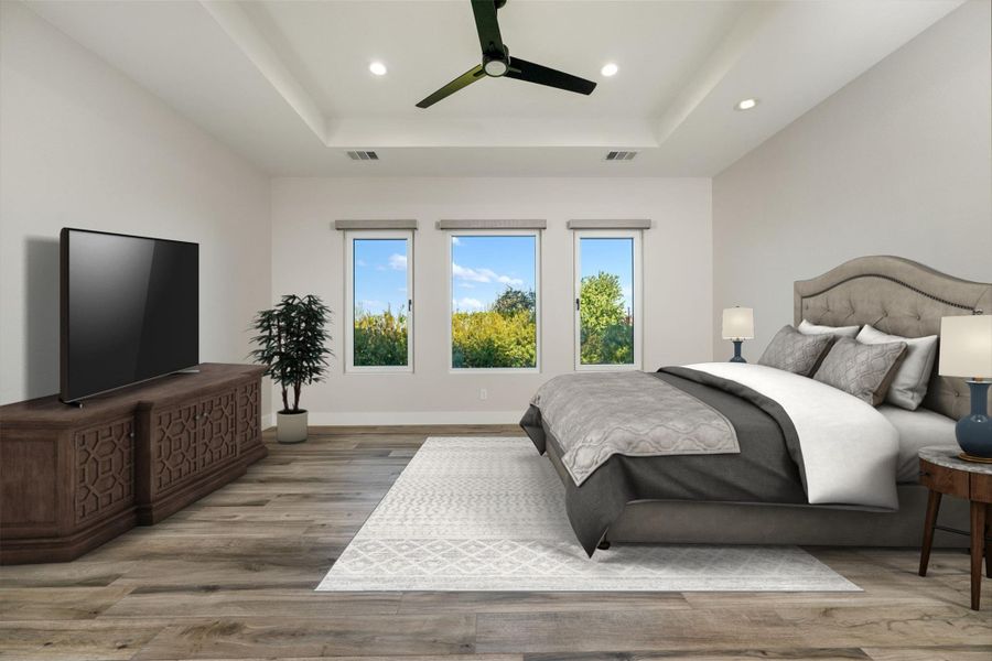 Bedroom featuring ceiling fan, a raised ceiling, and hardwood / wood-style flooring