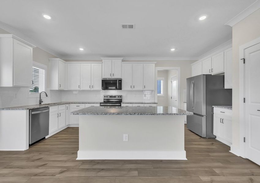 The kitchen has designer wood cabinetry.