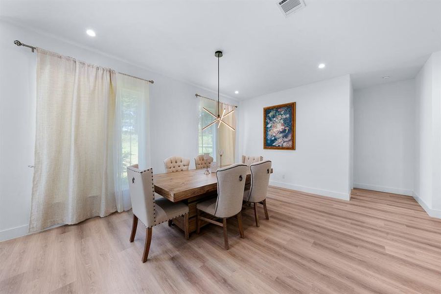 Dining space featuring a chandelier, light wood-style floors, and recessed lighting Dining space featuring a chandelier, light wood-style floors, and recessed lighting