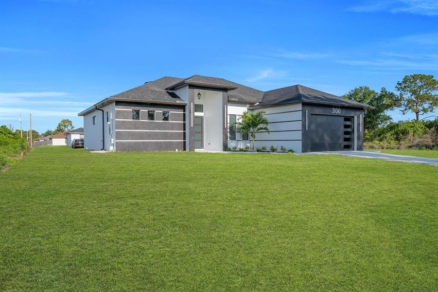 Front exterior of a new home in , Lehigh Acres, FL, highlighting curb appeal (Image 20).