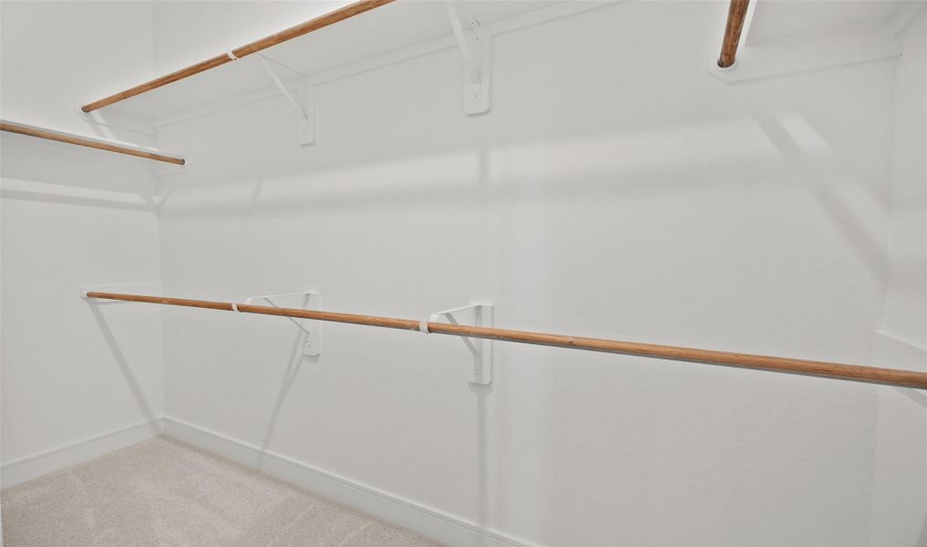 Walk-in closet in primary suite (*Photo not of actual home and used for illustration purposes only.) Walk-in closet in primary suite (*Photo not of actual home and used for illustration purposes only.)