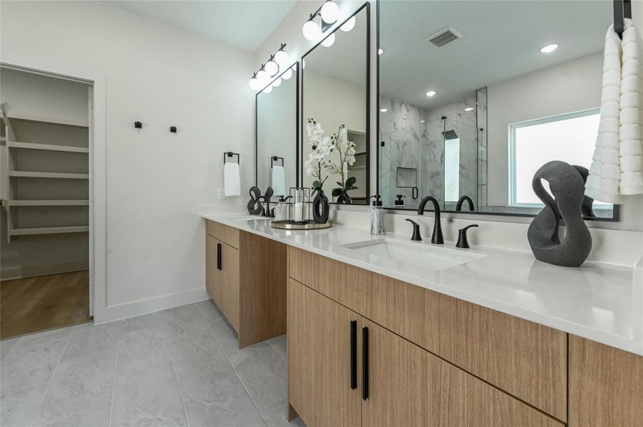 Spa primary bathroom offers double sinks, vanity area, stand alone fub & walk in shower