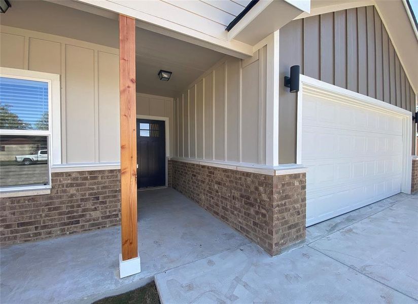 A welcoming entry offers a blend of brick and siding, complemented by a prominent garage door. A welcoming entry offers a blend of brick and siding, complemented by a prominent garage door.