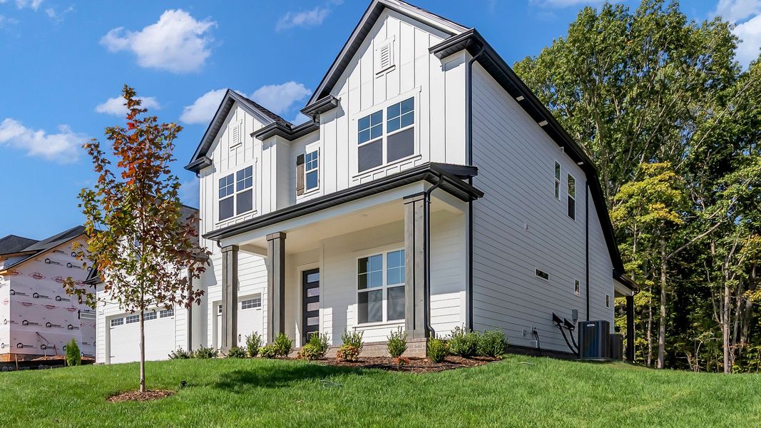 Front Exterior of Home with 3-car garage and overed front porch (Representative of completed home)