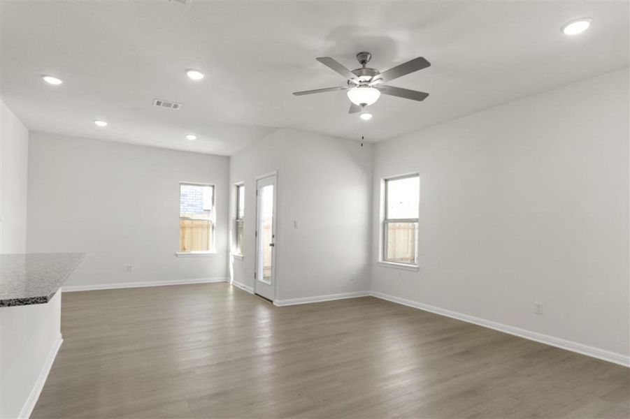 Unfurnished room with baseboards, visible vents, wood finished floors, and recessed lighting