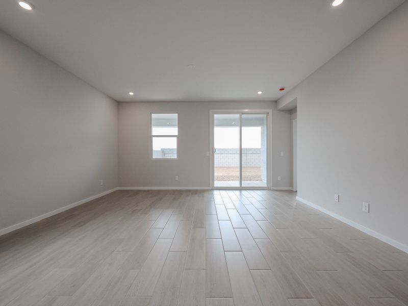 A room with a wood floor and windows.