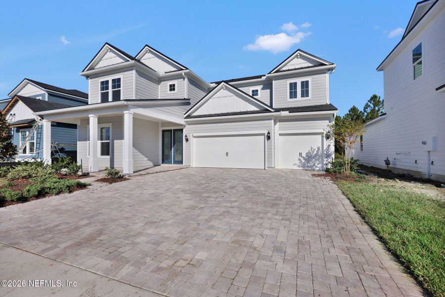 Front exterior of a new home in The Landings at Saint Johns, St. Johns, FL, highlighting curb appeal (Image 25).