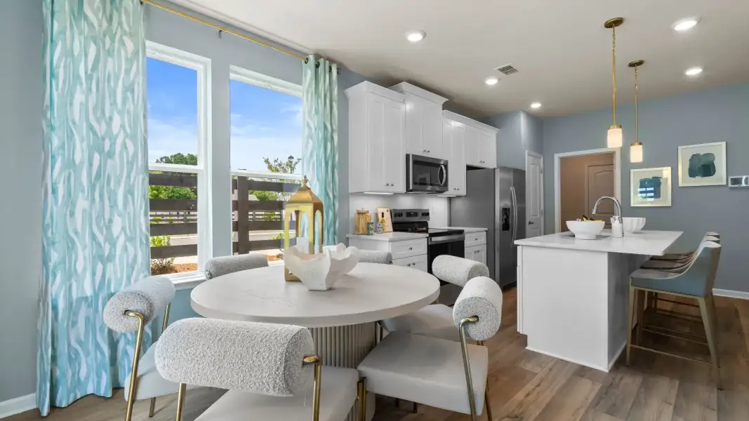 Breakfast area connecting to kitchen with natural light and bright modern features in the Luca at Avery Landing. Breakfast area connecting to kitchen with natural light and bright modern features in the Luca at Avery Landing.