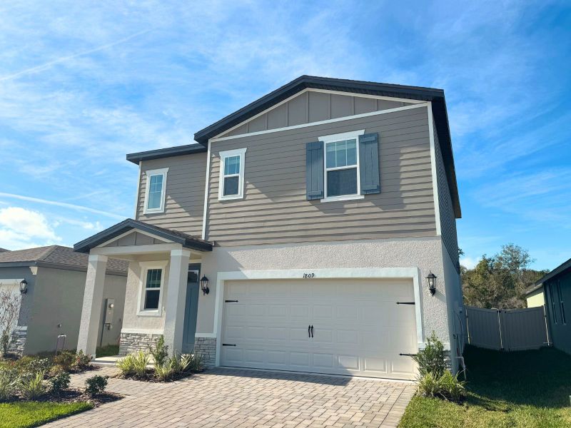 Front exterior of a new home in Two Rivers - Premier Series, Zephyrhills, FL, highlighting curb appeal (Image 2). Front exterior of a new home in Two Rivers - Premier Series, Zephyrhills, FL, highlighting curb appeal (Image 2).
