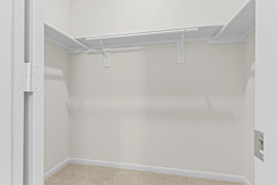 Spacious walk-in closet located within the primary suite, offering ample hanging space and built-in shelving—perfect for keeping everything organized and within easy reach! Spacious walk-in closet located within the primary suite, offering ample hanging space and built-in shelving—perfect for keeping everything organized and within easy reach!