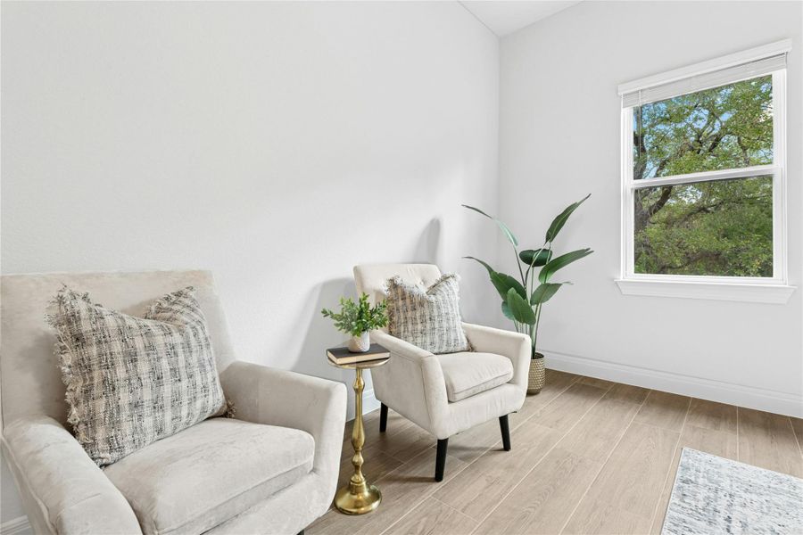 Living area featuring wood finished floors and baseboards Living area featuring wood finished floors and baseboards