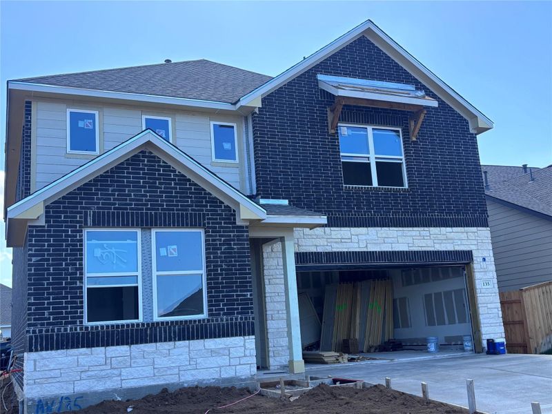 Front exterior of a new home in The Colony 45s, Bastrop, TX, highlighting curb appeal (Image 2).