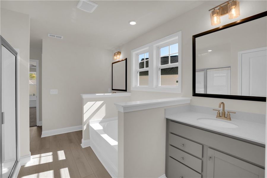 This spacious bathroom offers elegant fixtures and This spacious bathroom offers elegant fixtures and