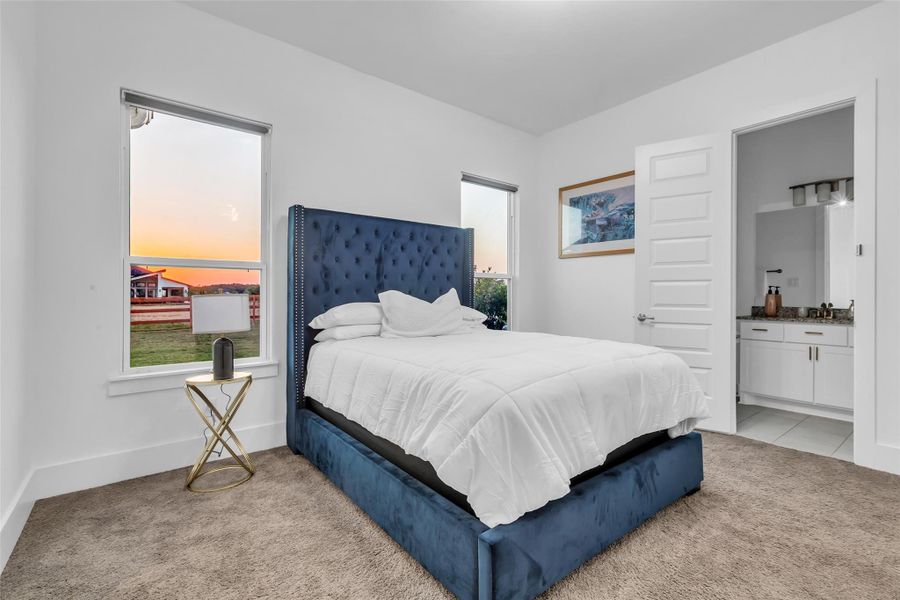 Private Bedroom Suite:Framed by picture windows capturing soft sunset views, this private suite blends serenity and style with a plush upholstered bed and a spa-inspired en suite just steps away, creating a restful retreat of quiet luxury.