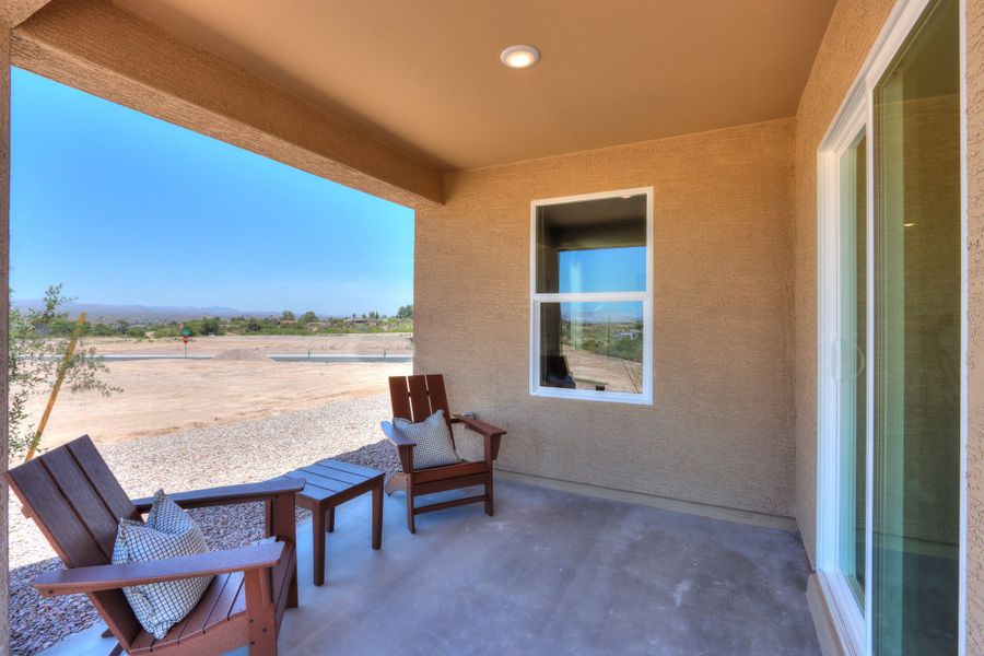 A patio with chairs and a table. A patio with chairs and a table.