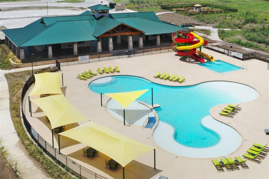 Community pool featuring a water slide, a patio, and a water play area