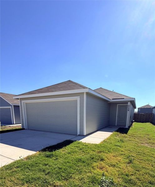 Ranch-style house featuring a front yard, driveway, and a garage Ranch-style house featuring a front yard, driveway, and a garage