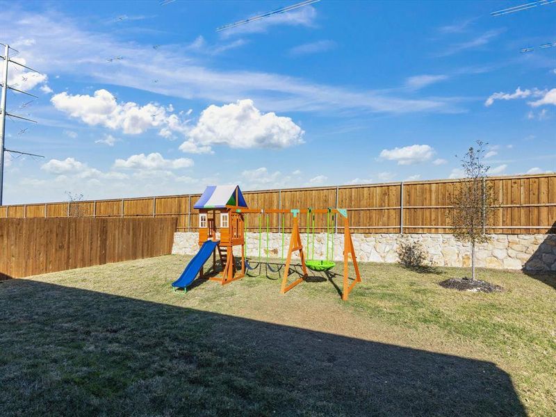 View of play area featuring a lawn