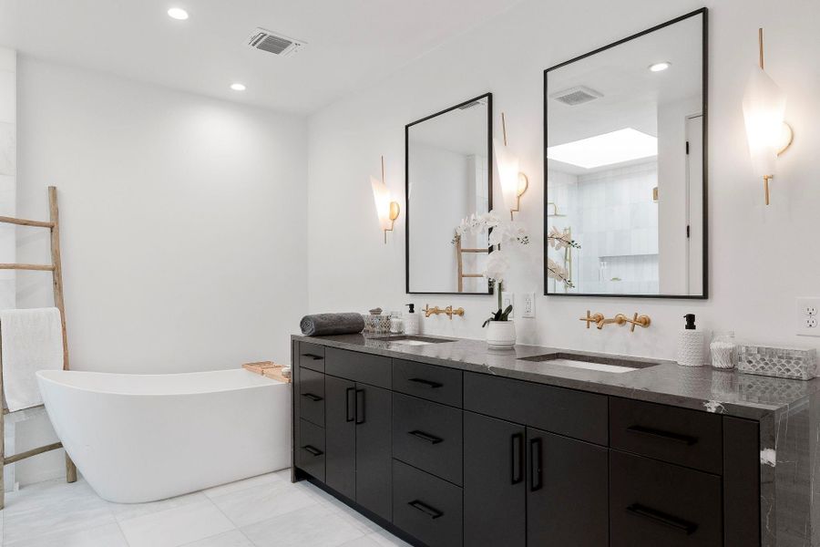 Enjoy your own deluxe ensuite bathroom with a designer dual vanity wrapped in marble countertops with under-mount sinks and tastefully selected luxury finishes.