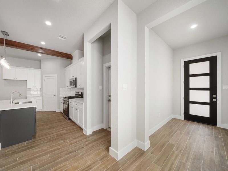 Kitchen is mix of navy blue island and white cabinets