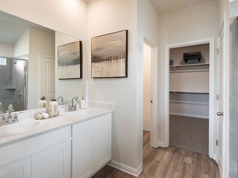 Find his-and-hers sinks, a walk-in shower, and spacious walk-in closet in the primary bath.