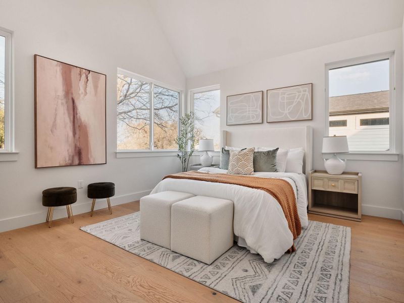 Bedroom featuring light wood finished floors and lofted ceiling