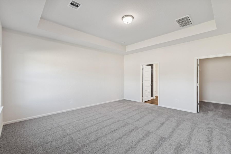 The Crawford- Primary Suite with Tray Ceiling. Sample image for illustration; upgrades, options, and colors may vary. The Crawford- Primary Suite with Tray Ceiling. Sample image for illustration; upgrades, options, and colors may vary.